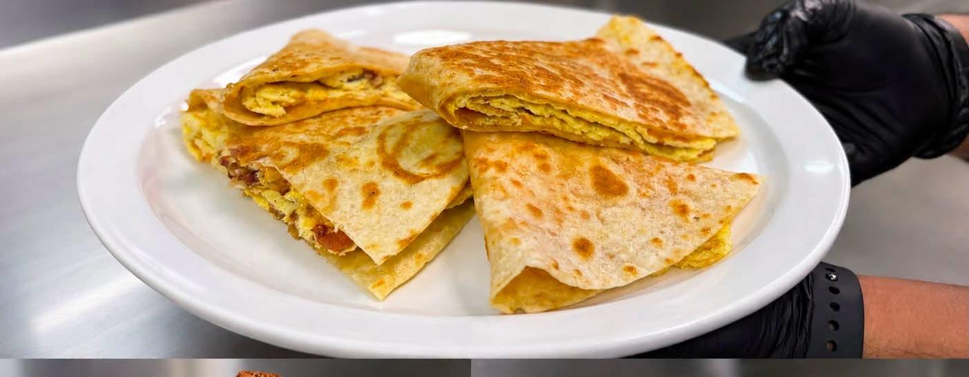 A breakfast quesadilla cut into wedges and plated