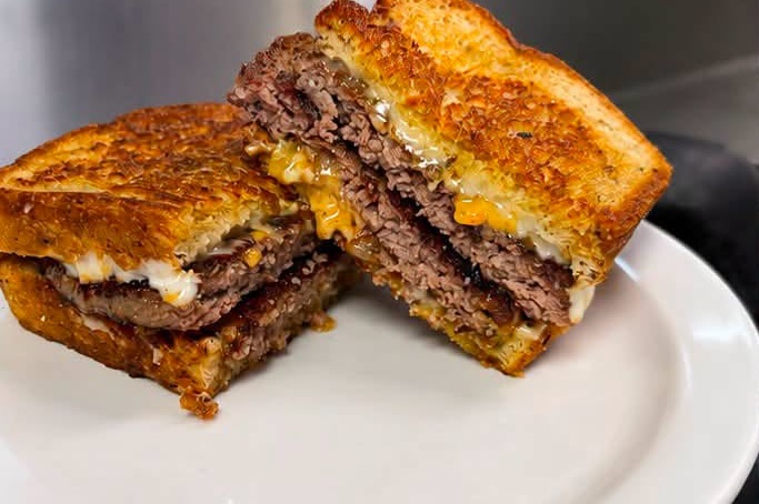A grilled sandwich cut through to show the filling